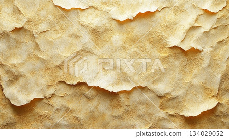 The layered texture of golden paper showcases soft, organic edges that add depth and warmth. This background enhances creative design projects, evoking a sense of sophistication. 134029052