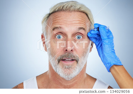 Syringe, portrait and surprise man of a senior face in a studio doing plastic surgery and cosmetic skincare. Dermatology, wrinkles and anti aging treatment of a mature model with filler injection Syringe, portrait and surprise man of a senior face in a studio doing plastic surgery and cosmetic skincare. Dermatology, wrinkles and anti aging treatment of a mature model with filler injection 134029056