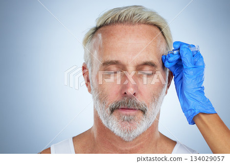 Needle, face and cosmetic of a senior man in a studio doing plastic surgery and cosmetic skincare. Dermatology, wrinkles and anti aging treatment of a mature model with silicone filler injection Needle, face and cosmetic of a senior man in a studio doing plastic surgery and cosmetic skincare. Dermatology, wrinkles and anti aging treatment of a mature model with silicone filler injection 134029057