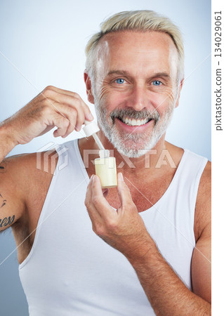 Beauty, skincare and serum with portrait of man in studio for anti aging, cosmetics and spa treatment. Product, facial and vitamin c with senior model on gray background for wrinkles, retinol and oil Beauty, skincare and serum with portrait of man in studio for anti aging, cosmetics and spa treatment. Product, facial and vitamin c with senior model on gray background for wrinkles, retinol and oil 134029061