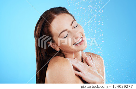 Water drop, shower and happy woman washing her body, skincare and self care isolated in a studio blue background. Aqua, beauty and female model cleaning her skin as wellness feeling calm and relaxed Water drop, shower and happy woman washing her body, skincare and self care isolated in a studio blue background. Aqua, beauty and female model cleaning her skin as wellness feeling calm and relaxed 134029277