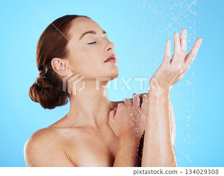 Shower, beauty and woman with water in studio for wellness, body hygiene and cleaning satisfaction. Skincare, girl and model on bathroom mockupwith hands for dermatology, luxury and washing products 134029308