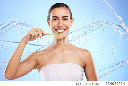 Portrait, water splash or happy woman brushing teeth with product for healthy oral or dental hygiene in studio. Face, smile beauty or girl model cleaning mouth with a natural bamboo wooden toothbrush Portrait, water splash or happy woman brushing teeth with product for healthy oral or dental hygiene in studio. Face, smile beauty or girl model cleaning mouth with a natural bamboo wooden toothbrush 134029334