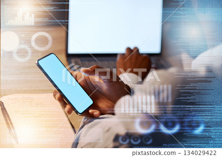 Businessman, phone and hands on laptop in analytics at night for corporate data or statistics on mockup screen. Hand of man working late on smartphone or computer display for app analysis on overlay Businessman, phone and hands on laptop in analytics at night for corporate data or statistics on mockup screen. Hand of man working late on smartphone or computer display for app analysis on overlay 134029422