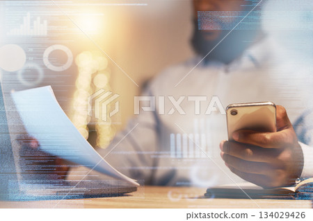 Businessman, hands and phone with document at night for corporate data, statistics or analytics at the office. Hand of black man working late on company finance or budget with smartphone on overlay Businessman, hands and phone with document at night for corporate data, statistics or analytics at the office. Hand of black man working late on company finance or budget with smartphone on overlay 134029426