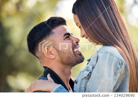Face, love and a couple in the garden together, feeling happy while dating for romance in summer. Smile, park or spring with a man and woman bonding outside in nature as a romantic partnership 134029690