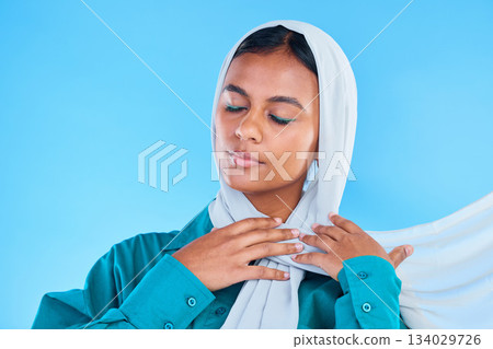Calm woman, muslim and beauty of hijab in studio, blue background or color backdrop. Young female model, islamic culture or scarf with eyes closed, peace or religion of arabic fashion for eid mubarak Calm woman, muslim and beauty of hijab in studio, blue background or color backdrop. Young female model, islamic culture or scarf with eyes closed, peace or religion of arabic fashion for eid mubarak 134029726