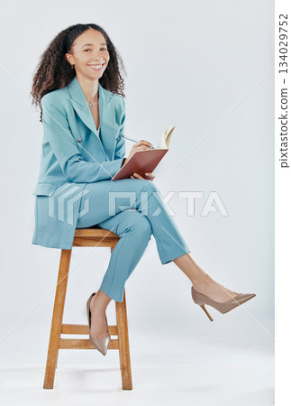 Planning, happy and a woman writing in a notebook isolated on a white background in a studio. Smile, creative and a girl in business sitting with a book for an agenda, ideas and notes on a backdrop Planning, happy and a woman writing in a notebook isolated on a white background in a studio. Smile, creative and a girl in business sitting with a book for an agenda, ideas and notes on a backdrop 134029752