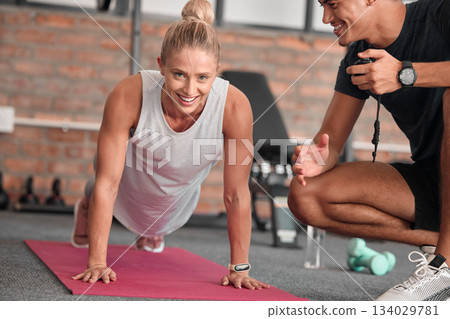 Push up, portrait of woman with personal trainer for gym coaching support, performance help and muscle goals. Athlete, sports and happy people in strong workout, exercise or health training challenge Push up, portrait of woman with personal trainer for gym coaching support, performance help and muscle goals. Athlete, sports and happy people in strong workout, exercise or health training challenge 134029781
