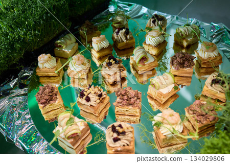 Elegant mushroom appetizer display, Serving tray featuring mushroom inspired treats, Artfully arranged decorative tray with creamy mushroom topped toasted bread slices Elegant mushroom appetizer display, Serving tray featuring mushroom inspired treats, Artfully arranged decorative tray with creamy mushroom topped toasted bread slices 134029806