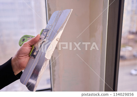 The Wall Repair Process Involves Properly Using Spackling Paste for a Quality Finish 134029856