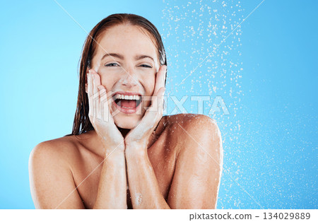 Woman in shower, happy in portrait with hygiene and water drops, soap and clean with excited face on blue background. Facial, hydration and skincare with female cleaning body, foam and mockup space Woman in shower, happy in portrait with hygiene and water drops, soap and clean with excited face on blue background. Facial, hydration and skincare with female cleaning body, foam and mockup space 134029889