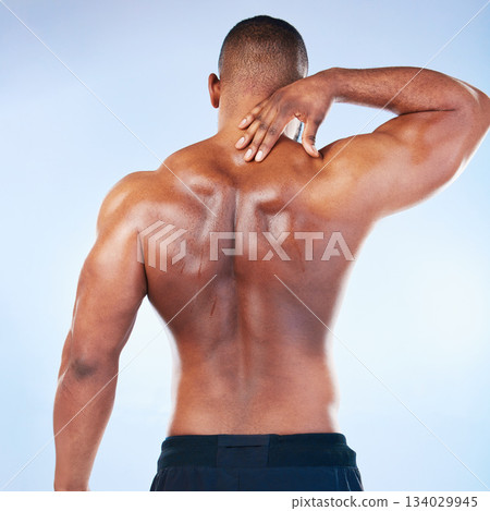 Black man, neck pain and injury with exercise and health, medical problem and aching body with back view. Emergency, muscle tension and male athlete with joint ache from workout on blue background Black man, neck pain and injury with exercise and health, medical problem and aching body with back view. Emergency, muscle tension and male athlete with joint ache from workout on blue background 134029945