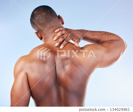 Black man, neck pain and injury with fitness and health, medical problem and aching body with back view. Emergency, muscle tension and male athlete with joint ache from workout on blue background 134029961
