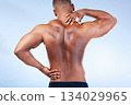 Black man, neck pain and back injury with fitness and health, medical problem and aching body in studio. Emergency, muscle tension and male athlete with joint ache from workout on blue background 134029965