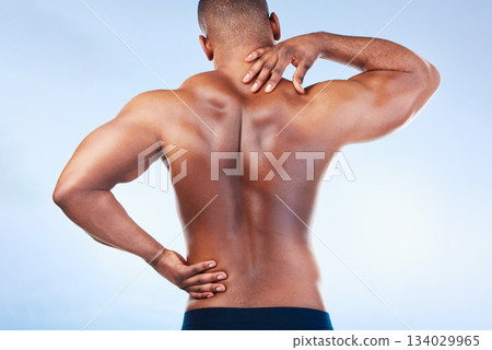Black man, neck pain and back injury with fitness and health, medical problem and aching body in studio. Emergency, muscle tension and male athlete with joint ache from workout on blue background 134029965