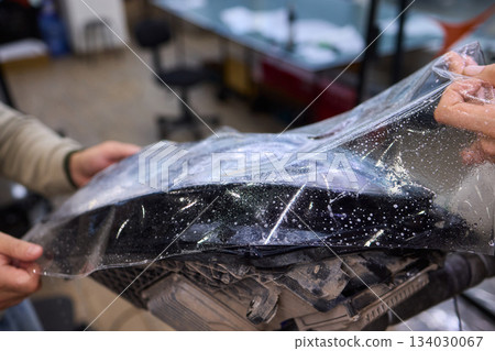 Applying a Protective Film on the Surface of Your Car for Enhanced Durability and Shine Applying a Protective Film on the Surface of Your Car for Enhanced Durability and Shine 134030067