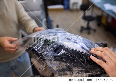 Applying a Protective Film on the Surface of Your Car for Enhanced Durability and Shine Applying a Protective Film on the Surface of Your Car for Enhanced Durability and Shine 134030070