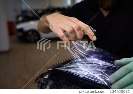 Applying a Protective Film on the Surface of Your Car for Enhanced Durability and Shine Applying a Protective Film on the Surface of Your Car for Enhanced Durability and Shine 134030085