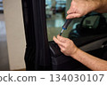 Mechanic fixing vehicle door parts, Closeup of technician repairing car interior components, Professional worker servicing vehicle door with detailed focus and tools 134030107