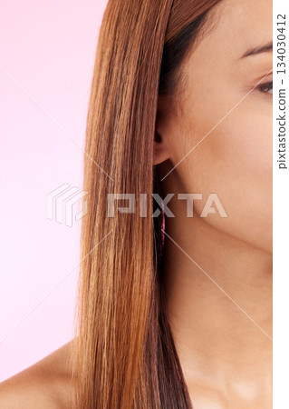 Zoom, hair and half face of black woman isolated in studio in pink background for beauty salon advertising. Haircare, straightener and Brazilian hairstyle on model for luxury growth product promotion 134030412