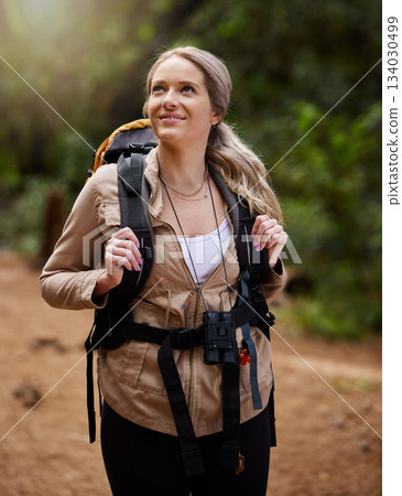 Hiking, smile and forest with a woman outdoor, walking in nature or the wilderness for adventure. Freedom, thinking and woods with an attractive young female hiker taking a walk in a natural park Hiking, smile and forest with a woman outdoor, walking in nature or the wilderness for adventure. Freedom, thinking and woods with an attractive young female hiker taking a walk in a natural park 134030499
