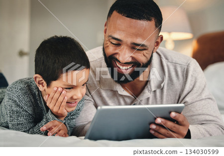 Dad, son and bed with tablet for bonding, love and streaming movies on web app with happiness. Man, kid and bedroom in family home with mobile touchscreen ux for gaming, e learning and relax together Dad, son and bed with tablet for bonding, love and streaming movies on web app with happiness. Man, kid and bedroom in family home with mobile touchscreen ux for gaming, e learning and relax together 134030599