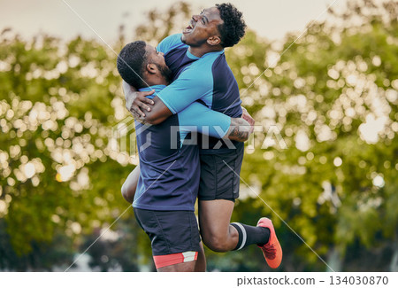 Rugby men, hug and celebration at game for winning, teamwork and success on field for sports. Team building, jumping and support for sport friends, goals and winner to celebrate achievement together 134030870