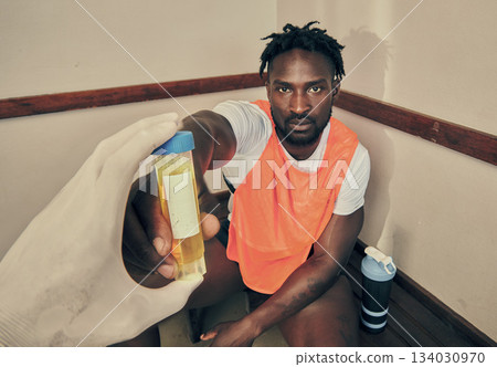 Sports, doctor and a portrait of a black man with a pee test to check for cheating or drug use. Analysis, giving and an African sport player with a urine sample for testing during fitness practice 134030970
