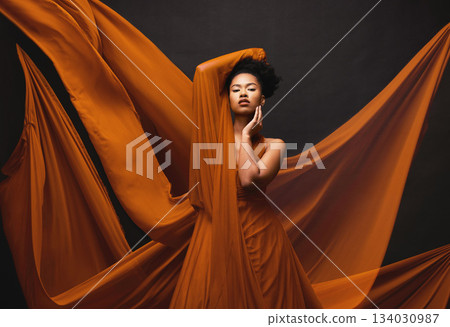 Black woman, art and fashion, flowing fabric on dark background with beauty and aesthetic movement. Silk, fantasy and artistic portrait of serious African model in creative designer dress in studio. Black woman, art and fashion, flowing fabric on dark background with beauty and aesthetic movement. Silk, fantasy and artistic portrait of serious African model in creative designer dress in studio. 134030987