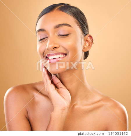 Indian woman, face and beauty with smile, skincare with natural cosmetics glow on studio background. Happy female, eyes closed and cosmetic care, dermatology and facial treatment wellness and makeup Indian woman, face and beauty with smile, skincare with natural cosmetics glow on studio background. Happy female, eyes closed and cosmetic care, dermatology and facial treatment wellness and makeup 134031152