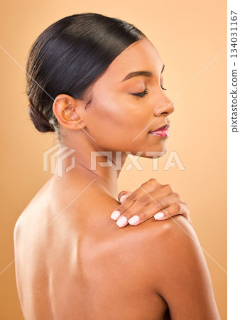 Beauty, face and skin of woman in studio for skincare, cosmetic, dermatology or makeup. Aesthetic female .profile and hand for self care, natural glow and facial shine or bodycare on brown background 134031167