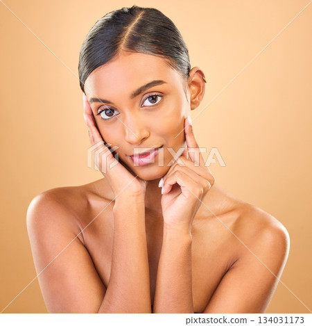 Skincare, face portrait and beauty of woman in studio isolated on a brown background. Makeup, cosmetics and happy Indian female model with spa facial treatment for healthy, glow or flawless skin. 134031173