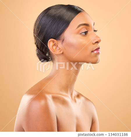 Beauty, face and profile of woman in studio for skincare, cosmetics, dermatology or makeup. Aesthetic female .serious about self care, natural skin and spa facial shine results on a brown background Beauty, face and profile of woman in studio for skincare, cosmetics, dermatology or makeup. Aesthetic female .serious about self care, natural skin and spa facial shine results on a brown background 134031186
