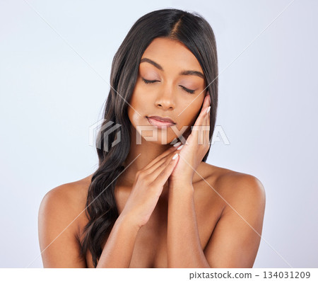 Face of woman, hair care or eyes closed in studio for healthy natural shine, keratin or spa beauty on white background. Glowing girl, beautiful Indian model or salon self care cosmetics in grooming Face of woman, hair care or eyes closed in studio for healthy natural shine, keratin or spa beauty on white background. Glowing girl, beautiful Indian model or salon self care cosmetics in grooming 134031209