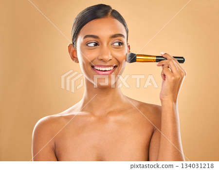 Indian woman, beauty and brush for makeup with smile, cosmetic tools, skin glow and face on studio background. Happy female, thinking and cosmetology, apply foundation or powder with self care Indian woman, beauty and brush for makeup with smile, cosmetic tools, skin glow and face on studio background. Happy female, thinking and cosmetology, apply foundation or powder with self care 134031218