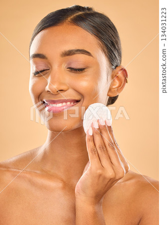 Skin, beauty and face cotton of woman in studio for cosmetics, dermatology or makeup. Aesthetic female .hand with product for self care, remove makeup and natural facial results on a brown background Skin, beauty and face cotton of woman in studio for cosmetics, dermatology or makeup. Aesthetic female .hand with product for self care, remove makeup and natural facial results on a brown background 134031223