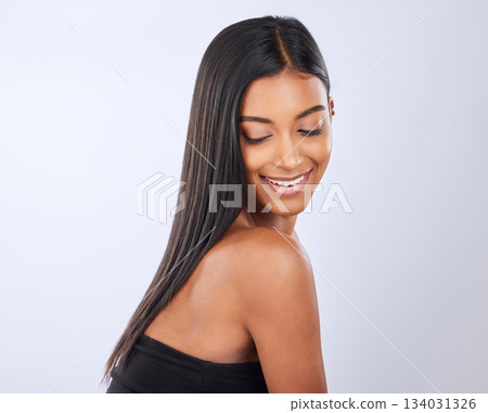 Happy, hair care or Indian woman in studio for beauty, healthy natural shine, growth or wellness. Smile of glowing young girl model, self love or salon spa cosmetics in grooming on white background Happy, hair care or Indian woman in studio for beauty, healthy natural shine, growth or wellness. Smile of glowing young girl model, self love or salon spa cosmetics in grooming on white background 134031326