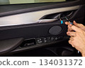 Mechanic fixing vehicle door parts, Closeup of technician repairing car interior components, Professional worker servicing vehicle door with detailed focus and tools 134031372