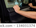 Mechanic fixing vehicle door parts, Closeup of technician repairing car interior components, Professional worker servicing vehicle door with detailed focus and tools 134031374