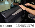 Mechanic fixing vehicle door parts, Closeup of technician repairing car interior components, Professional worker servicing vehicle door with detailed focus and tools 134031376