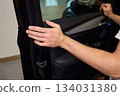 Mechanic fixing vehicle door parts, Closeup of technician repairing car interior components, Professional worker servicing vehicle door with detailed focus and tools 134031380