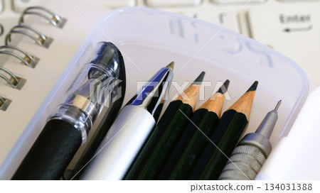 Writing implements and a computer Writing implements and a computer 134031388