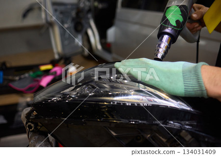 Applying a Protective Film on the Surface of Your Car for Enhanced Durability and Shine 134031409