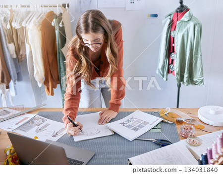 Design illustration, clothes designer and fashion employee working on creative design information. Textile, tailor and sewing planning of a woman planning a drawing, sketch and workshop studio job 134031840