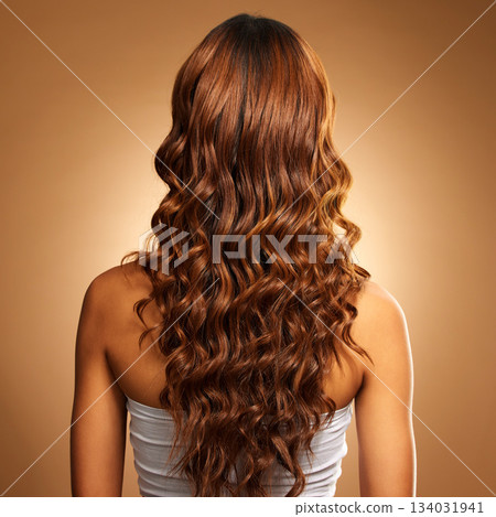 Back of hair, curls and woman for beauty, wellness and keratin treatment on brown background. Hairdresser mockup, salon studio and girl with curly hairstyle for growth, haircare texture or cosmetics Back of hair, curls and woman for beauty, wellness and keratin treatment on brown background. Hairdresser mockup, salon studio and girl with curly hairstyle for growth, haircare texture or cosmetics 134031941