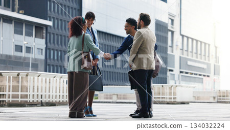 Business people, meeting or handshake with team in city for introduction, greeting or collaboration. Group, employees or colleagues shaking hands with smile for partnership or agreement in urban town Business people, meeting or handshake with team in city for introduction, greeting or collaboration. Group, employees or colleagues shaking hands with smile for partnership or agreement in urban town 134032224