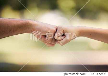 Teamwork, fist bump and people with outdoor support, collaboration and team building mission or agreement. Man, woman partner or couple of friends with deal, challenge or power hands sign in a park Teamwork, fist bump and people with outdoor support, collaboration and team building mission or agreement. Man, woman partner or couple of friends with deal, challenge or power hands sign in a park 134032244