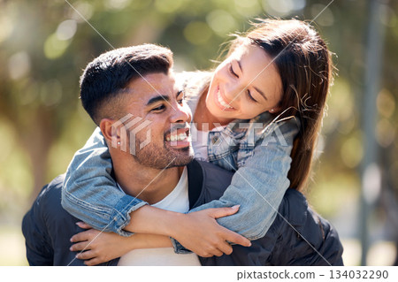 Couple, outdoor and piggy back with a smile for love, care and happiness together in summer. Young man and woman at nature park for affection or hug on a happy and romantic date or vacation to relax 134032290