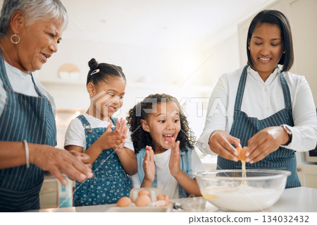 Grandmother, mom or excited children baking in kitchen as a happy family with young girl learning a recipe. Cracking eggs, clapping or grandma smiling or teaching kids to bake a cake for development Grandmother, mom or excited children baking in kitchen as a happy family with young girl learning a recipe. Cracking eggs, clapping or grandma smiling or teaching kids to bake a cake for development 134032432